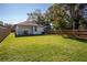 Expansive backyard featuring lush green grass and a privacy fence; great for outdoor activities at 1808 E Comanche Ave, Tampa, FL 33610