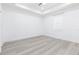 An airy bedroom showcasing modern flooring and a tray ceiling for a clean, minimalist aesthetic at 1808 E Comanche Ave, Tampa, FL 33610