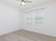 Bright bedroom features light walls, vinyl floors, a ceiling fan and two windows at 1808 E Comanche Ave, Tampa, FL 33610