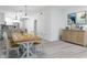 Open-concept dining room with a wooden table, seating for eight, and stylish decor at 1808 E Comanche Ave, Tampa, FL 33610
