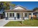 Charming renovated home with a manicured lawn and inviting front porch, showcasing curb appeal at 1808 E Comanche Ave, Tampa, FL 33610