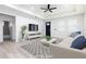 Bright living room featuring a ceiling fan, plush couch, modern rug, and neutral tones creating an inviting space at 1808 E Comanche Ave, Tampa, FL 33610