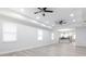 Spacious living room with light gray flooring, recessed lighting, and a view into the modern kitchen at 1808 E Comanche Ave, Tampa, FL 33610