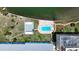 A beautiful aerial view of a bayside community with a pool and tennis courts at 1847 Shore S Dr # 204, South Pasadena, FL 33707