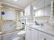 A practical bathroom includes a tub with shower, tile accents, vanity with a sink and a toilet at 1847 Shore S Dr # 204, South Pasadena, FL 33707