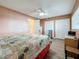 Cozy bedroom with a ceiling fan, wood-look floors, and ample closet space at 1847 Shore S Dr # 204, South Pasadena, FL 33707