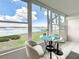 Bright breakfast nook features stunning water views from the large windows and a glass table with seating for two at 1847 Shore S Dr # 204, South Pasadena, FL 33707