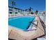 Close-up of refreshing waterfront pool with chair and ladder entry points at 1847 Shore S Dr # 204, South Pasadena, FL 33707
