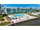Waterfront community pool with lounge chairs, umbrellas, and scenic views at 1847 Shore S Dr # 204, South Pasadena, FL 33707