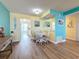 Bright dining area with seating for four, complemented by a view into the kitchen and colorful wall decor at 1847 Shore S Dr # 204, South Pasadena, FL 33707