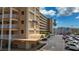 Exterior view of the building highlighting architectural details, parking area, and well-maintained surroundings at 1847 Shore S Dr # 204, South Pasadena, FL 33707