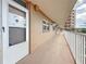 Exterior hallway leading to Unit 204, offering a view of the building's structure and surroundings at 1847 Shore S Dr # 204, South Pasadena, FL 33707