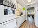 Charming kitchen with white cabinets, gas cooktop, and a view of the adjacent living spaces at 1847 Shore S Dr # 204, South Pasadena, FL 33707
