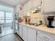 Updated kitchen features white cabinetry, tiled backsplash, and modern appliances in a cozy layout at 1847 Shore S Dr # 204, South Pasadena, FL 33707