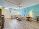 Bright living room with blue and yellow accent walls featuring comfortable sofas and wood-look flooring at 1847 Shore S Dr # 204, South Pasadena, FL 33707