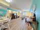 Open-concept living area with wood-look floors, comfortable seating, and bright, colorful decor at 1847 Shore S Dr # 204, South Pasadena, FL 33707