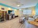 Inviting living room featuring a floral sofa, entertainment center, and bright natural light at 1847 Shore S Dr # 204, South Pasadena, FL 33707