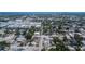 An aerial shot captures the neighborhood's layout, blending commercial and residential properties among lush greenery at 1923 W State St, Tampa, FL 33606