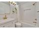 Updated bathroom showcasing a shower-over-tub, gold fixtures, and contemporary white vanity at 1923 W State St, Tampa, FL 33606