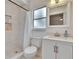 Updated bathroom features a walk-in shower, modern fixtures, and a vanity with storage at 1923 W State St, Tampa, FL 33606