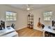 Versatile bedroom featuring wood floors, large windows, ceiling fan, and desk space at 1923 W State St, Tampa, FL 33606