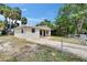 Charming home featuring a well-manicured lawn, brick walkway, neutral paint, and mature landscaping at 1923 W State St, Tampa, FL 33606