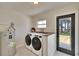 Functional laundry room with side-by-side washer and dryer, countertop, and outdoor access at 1923 W State St, Tampa, FL 33606