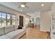 Sunlit living room with a comfortable sofa, wood floors, and access to the dining room at 1923 W State St, Tampa, FL 33606