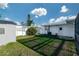 Grassy backyard featuring a storage shed and an additional privacy fence at 2030 Magnolia Dr, Clearwater, FL 33764