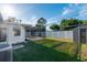 Lush backyard featuring a screened-in patio and an exterior storage shed at 2030 Magnolia Dr, Clearwater, FL 33764