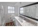 Updated bathroom with a modern vanity, large mirror, and a shower-tub combo at 2030 Magnolia Dr, Clearwater, FL 33764