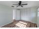 Serene bedroom featuring wood floors, a ceiling fan, and a spacious closet at 2030 Magnolia Dr, Clearwater, FL 33764