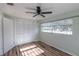 Bedroom with wood floors, a ceiling fan, and a closet featuring sliding doors at 2030 Magnolia Dr, Clearwater, FL 33764