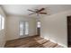 Cozy bedroom with wood floors, ceiling fan, and natural light filtering through french doors at 2030 Magnolia Dr, Clearwater, FL 33764