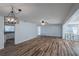Spacious living area with sleek flooring, modern light fixture, and open access to the kitchen at 2030 Magnolia Dr, Clearwater, FL 33764