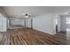 Spacious living room with wood floors, ceiling fan, and ample natural light from large mirror at 2030 Magnolia Dr, Clearwater, FL 33764