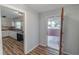 Open floor plan with kitchen featuring white cabinets and stainless steel appliances at 2030 Magnolia Dr, Clearwater, FL 33764