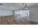 Open-concept living room with stylish wood floors, contemporary lighting, and a bright, airy feel at 2030 Magnolia Dr, Clearwater, FL 33764