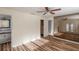 Main bedroom featuring wood floors, large mirrored wall, and ensuite bathroom access at 2030 Magnolia Dr, Clearwater, FL 33764