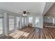 Cozy sunroom featuring lots of natural light, wood floors, and glass doors leading outdoors at 2030 Magnolia Dr, Clearwater, FL 33764