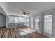 Bright sunroom featuring wood flooring, white trim, and multiple windows for natural light at 2030 Magnolia Dr, Clearwater, FL 33764