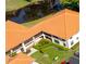 Beautiful aerial view of a condo with tile roof, lush landscaping, pond and parking at 2213 Hammock Pine Blvd, Clearwater, FL 33761
