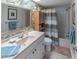 Bathroom showcasing a white vanity with storage and a shower-tub combination at 2213 Hammock Pine Blvd, Clearwater, FL 33761