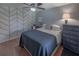 Bedroom featuring a blue accent wall, wood floors, and a queen bed with decorative pillows at 2213 Hammock Pine Blvd, Clearwater, FL 33761