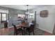 Charming dining room with a round table, four chairs, stylish light fixture, and wood accent wall at 2213 Hammock Pine Blvd, Clearwater, FL 33761
