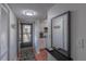 Inviting entryway with coat hooks, a mirror, and tile floor that leads into the kitchen at 2213 Hammock Pine Blvd, Clearwater, FL 33761