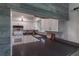 Bright kitchen with white cabinets, mosaic backsplash, modern appliances and dark countertops at 2213 Hammock Pine Blvd, Clearwater, FL 33761