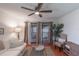 Comfortable living room with a white sofa, a view of the covered balcony, and bright natural light at 2213 Hammock Pine Blvd, Clearwater, FL 33761