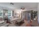 Bright living room with hardwood floors, comfortable seating, and sliding glass doors to the outside at 2213 Hammock Pine Blvd, Clearwater, FL 33761