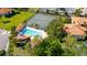 Stunning community pool, tennis courts, and tropical landscaping from an aerial view at 2213 Hammock Pine Blvd, Clearwater, FL 33761